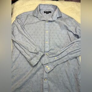 Light Blue long sleeve button down shirt with skull crossbones design.